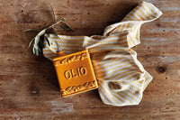 Honey-coloured handmade ceramic oil bottle with embossed Olio d’Oliva detail and cork stopper, rustic Italian tableware